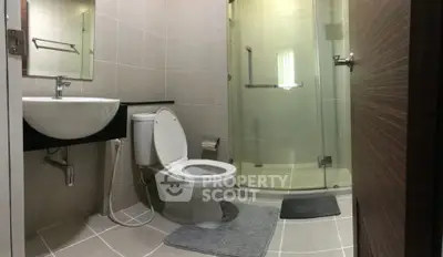 Modern bathroom with glass shower and sleek fixtures