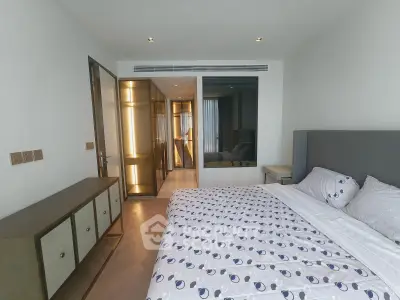 Modern bedroom with stylish decor and ensuite bathroom in luxury apartment
