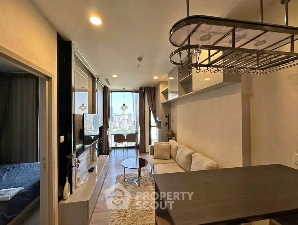 Modern living room with city view, cozy sofa, and stylish decor in a high-rise apartment.