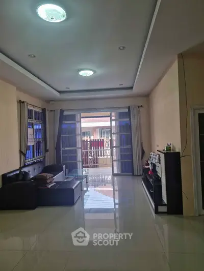 Spacious living room with modern decor and large windows for natural light.