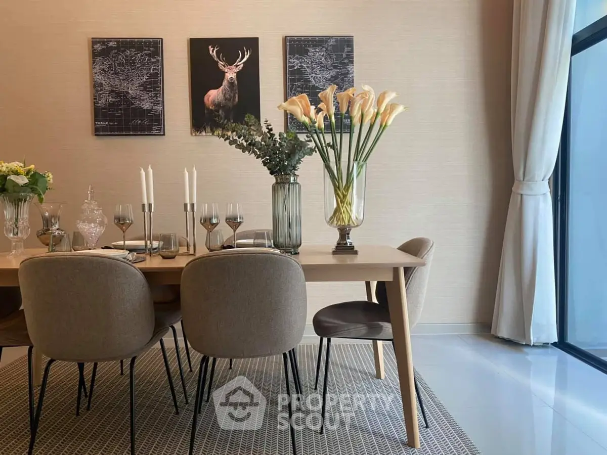 Elegant dining room with modern decor and large window for natural light.