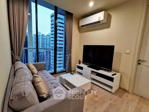 Modern living room with city view, featuring sleek furniture and large windows.