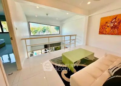 Stylish modern living room with mezzanine and artistic decor