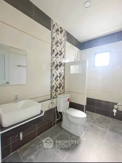 Modern bathroom with stylish tile design and natural light