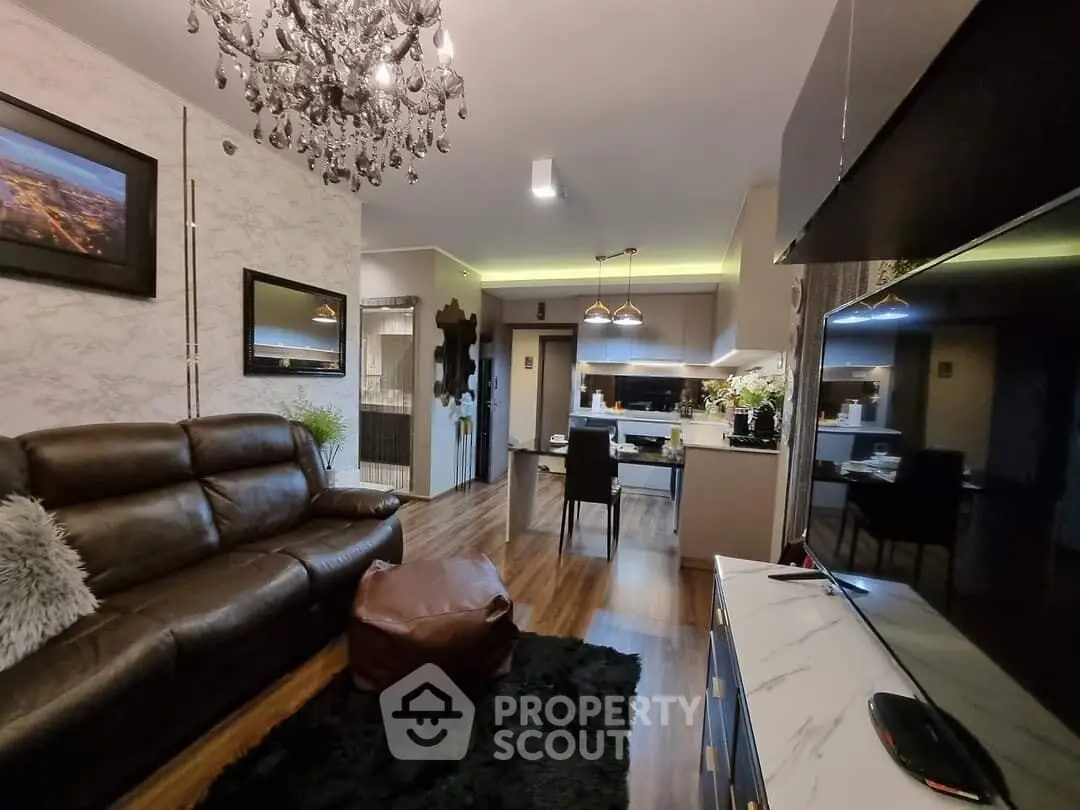 Luxurious living room with elegant chandelier and modern open kitchen layout