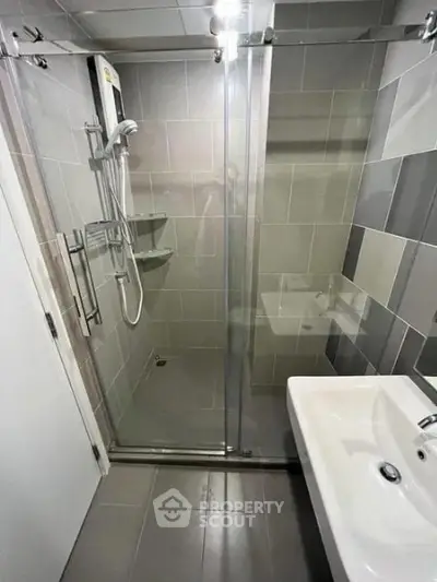 Modern bathroom with glass shower enclosure and sleek sink design