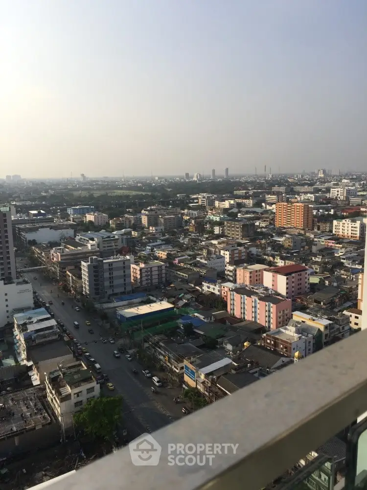 Stunning cityscape view from high-rise balcony overlooking urban skyline.