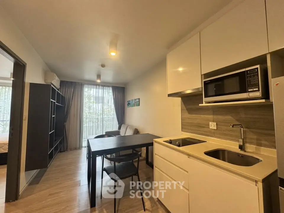 Modern open-plan kitchen and living area with sleek design and natural light.