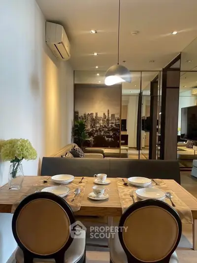 Stylish dining area with modern decor and cityscape artwork in a cozy apartment setting.