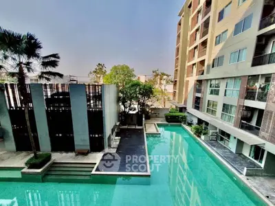 Luxurious apartment complex with stunning pool view and modern architecture.
