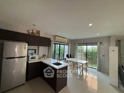 Modern open-layout kitchen and dining area with garden view