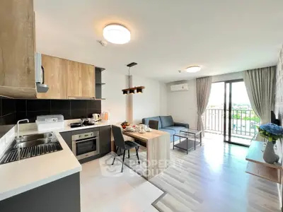 Modern open-layout kitchen and living room with balcony view