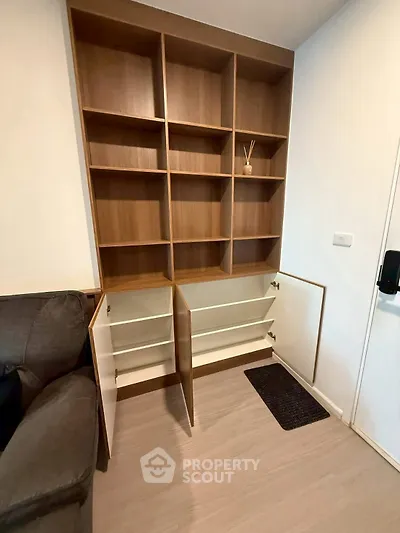 Modern living room with stylish wooden shelving unit and cozy sofa