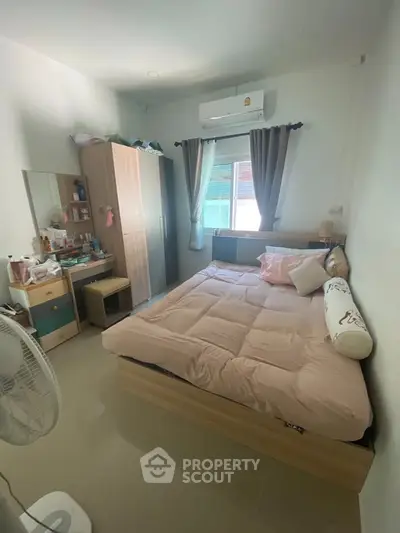 Cozy bedroom with modern furnishings and ample natural light