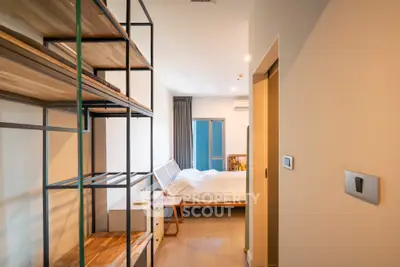 Modern bedroom with stylish shelving and cozy bed in a bright apartment