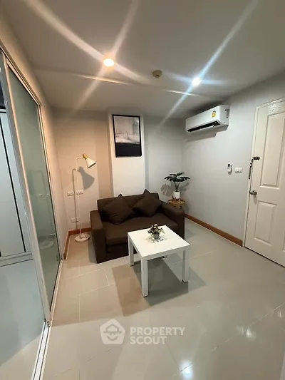 Cozy living room with modern decor and air conditioning in a stylish apartment.