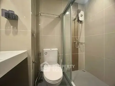 Modern bathroom with sleek shower and toilet in minimalist design.