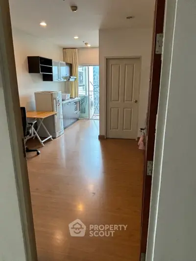 Cozy apartment interior with open kitchen and balcony view