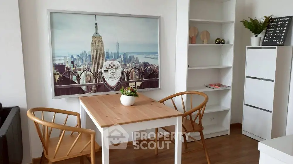Charming dining area with wooden table and chairs, featuring stylish decor and a large cityscape artwork.