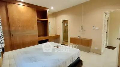 Spacious bedroom with built-in wardrobe and modern decor