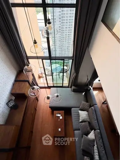 Stunning high-ceiling living room with floor-to-ceiling windows and city view