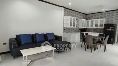 Spacious modern living room with open kitchen and stylish furniture