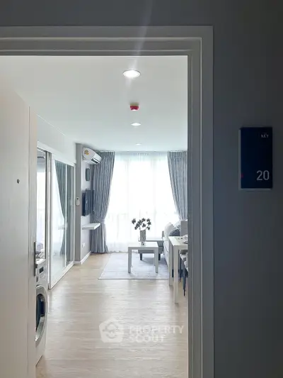 Modern living room with large windows and stylish decor in a cozy apartment.