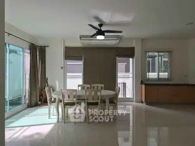 Spacious dining area with modern ceiling fan and natural light