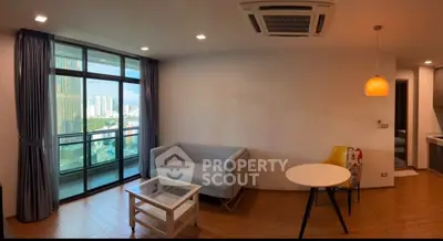 Modern living room with balcony view and stylish furniture in urban apartment