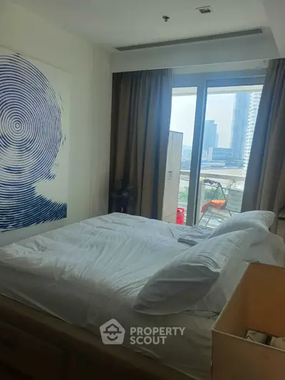 Modern bedroom with city view and stylish decor in high-rise apartment.