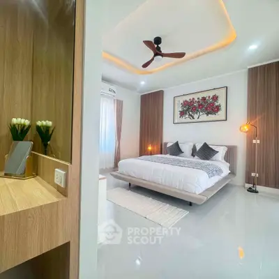 Luxurious modern bedroom with elegant decor and ambient lighting, featuring a stylish ceiling fan and cozy bedding.