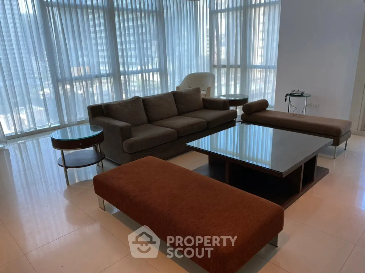 Spacious modern living room with elegant furniture and floor-to-ceiling windows