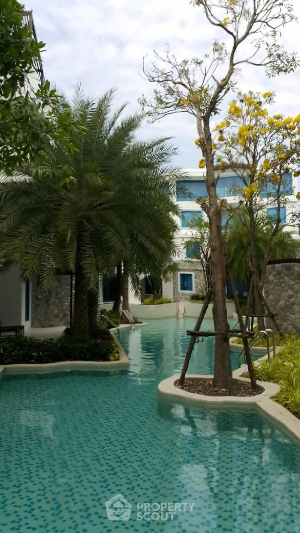 Luxurious residential pool area with lush landscaping and serene atmosphere