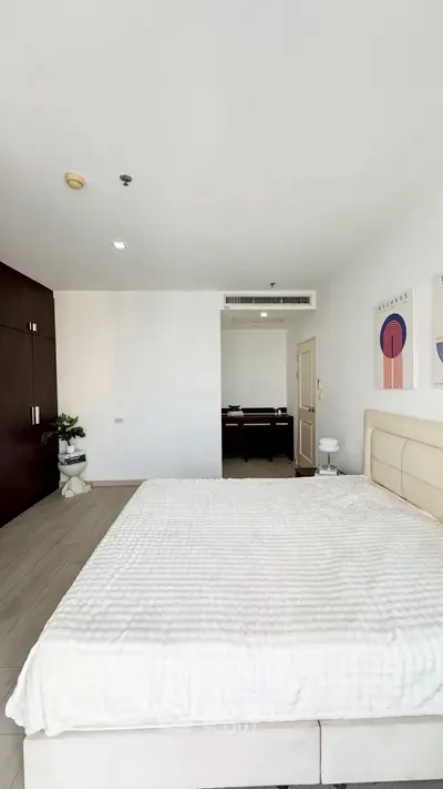 Spacious bedroom with modern decor and ample natural light