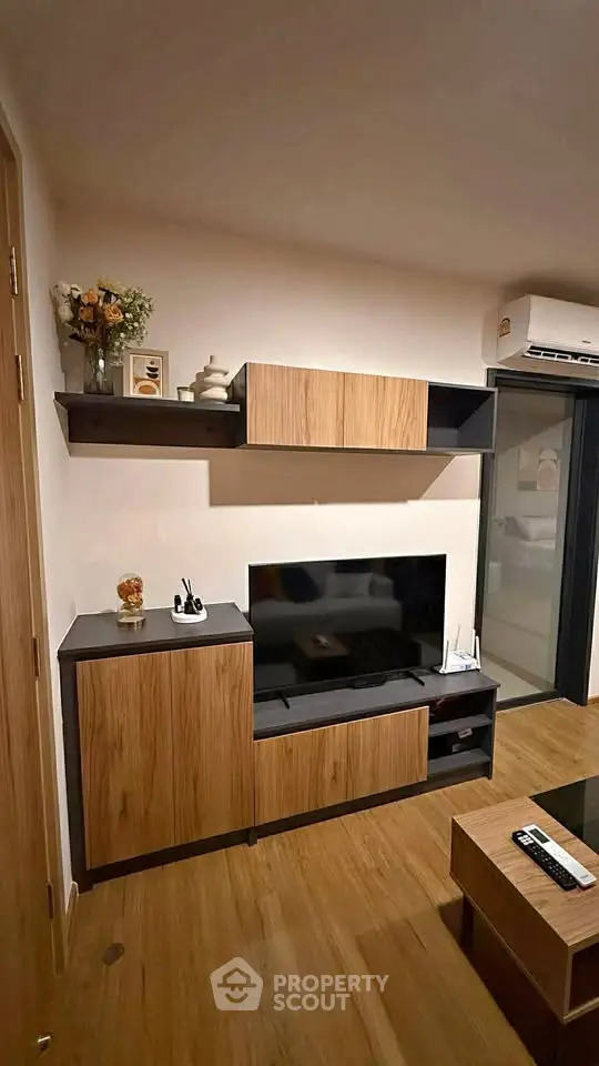 Modern living room with sleek wooden furniture and mounted TV, perfect for cozy relaxation.