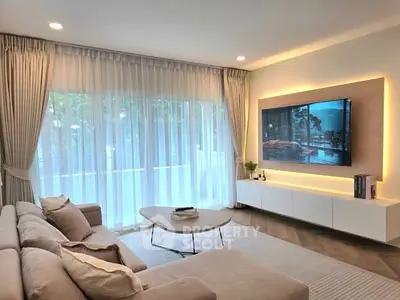 Elegant living room with modern decor and large window view