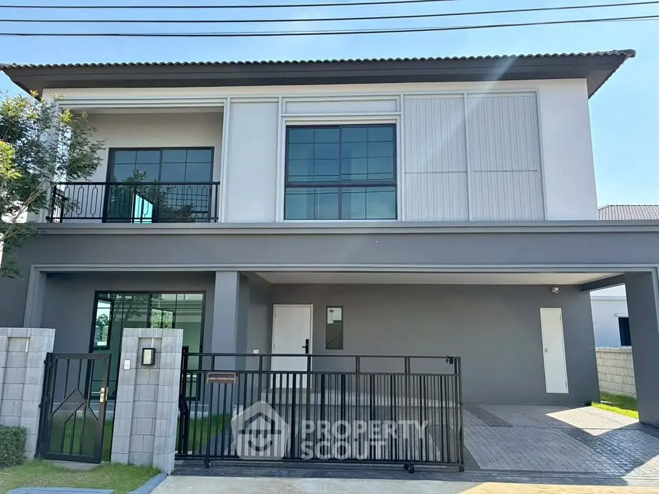 Modern two-story house with sleek design and spacious driveway in a serene neighborhood.