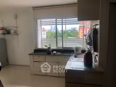 Charming kitchen with city view, featuring modern appliances and ample natural light.