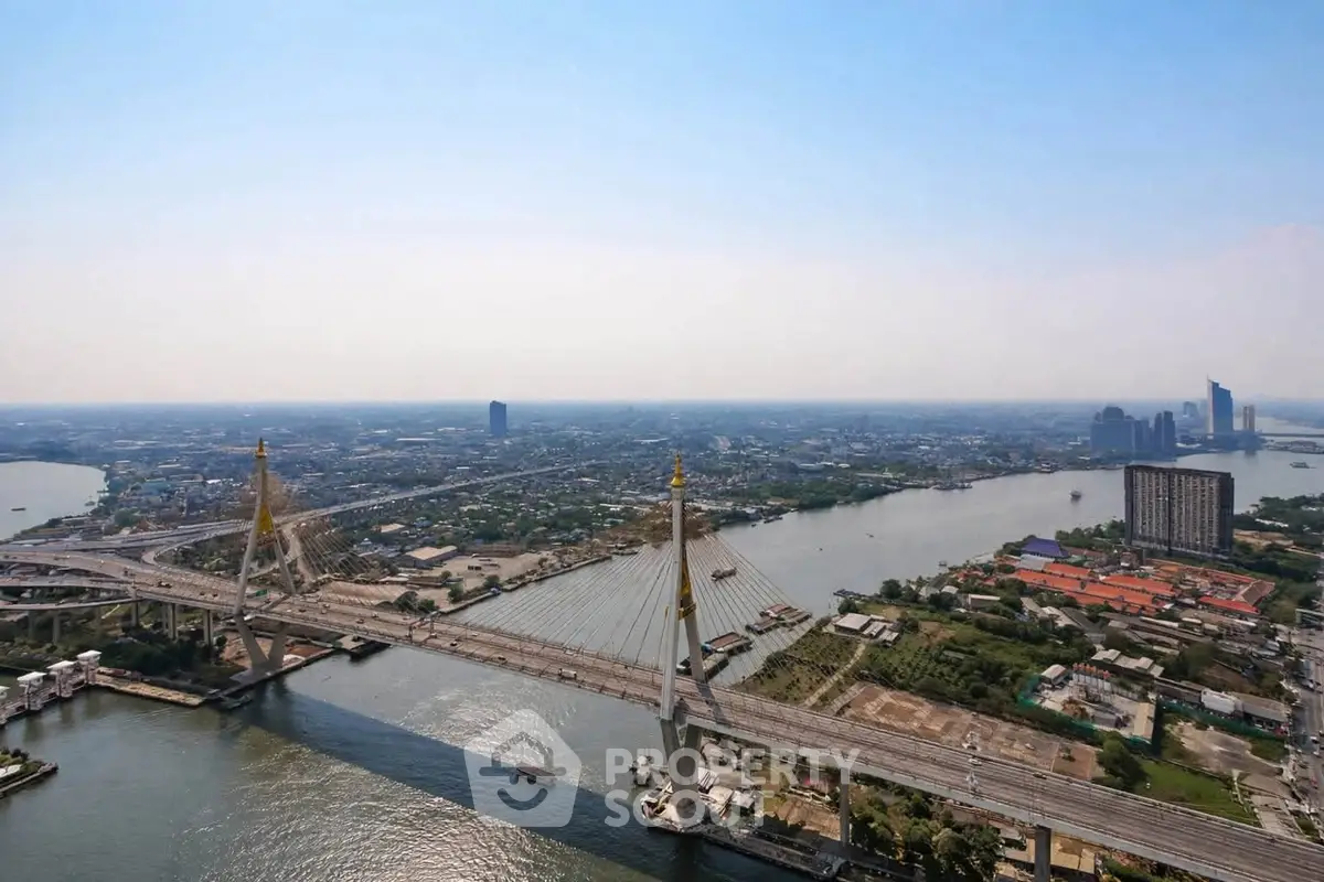Stunning aerial view of cityscape with iconic bridge and river, perfect for urban living enthusiasts.