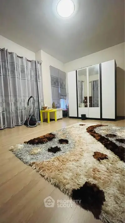Spacious bedroom with modern wardrobe and plush carpet, ideal for cozy living.