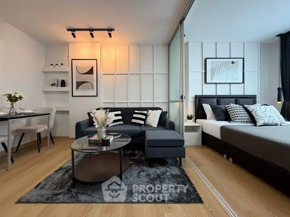 Modern open-plan living room and bedroom with stylish decor and cozy ambiance.
