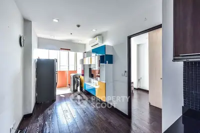 Modern kitchen with colorful cabinets and sleek appliances in a bright apartment