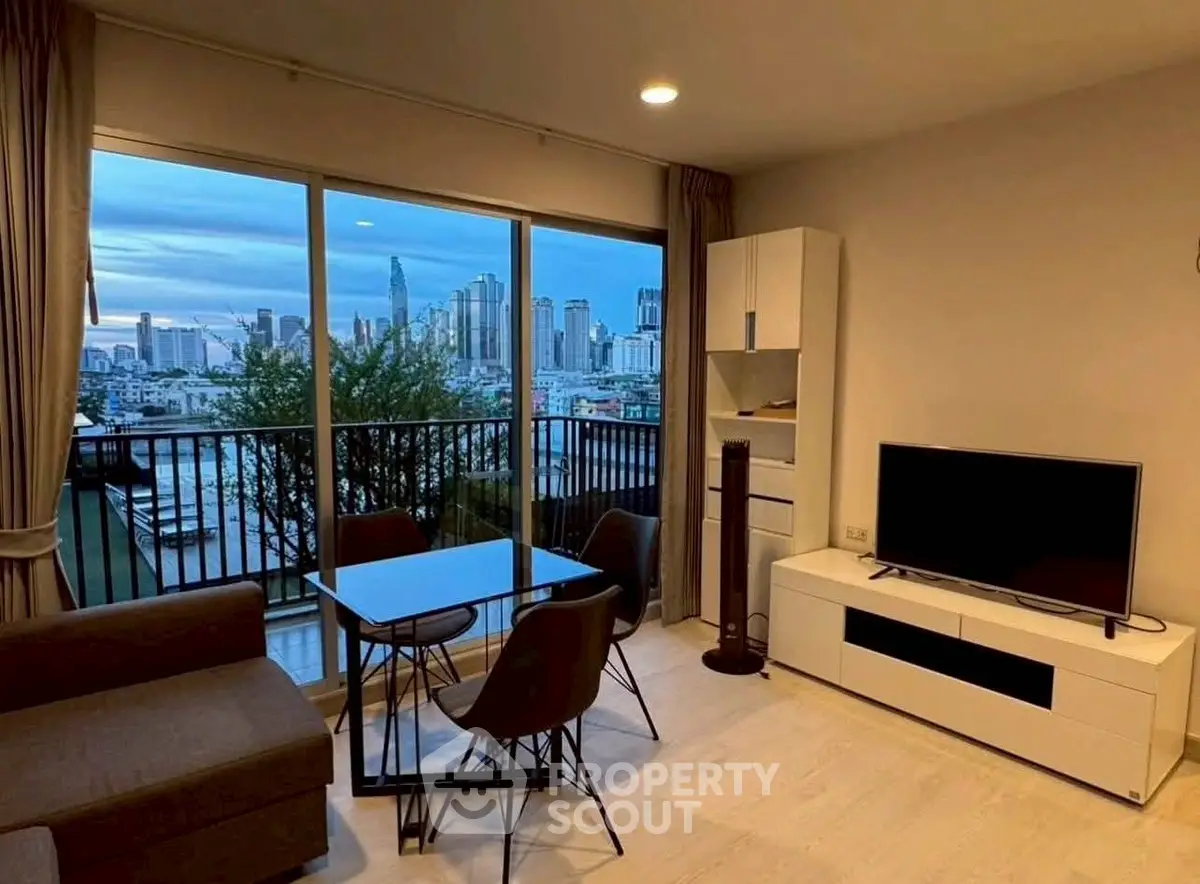 Modern living room with city view, featuring sleek furniture and large windows for natural light.