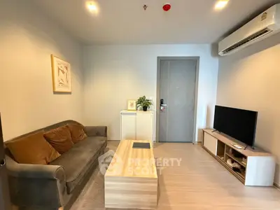 Modern living room with cozy sofa, stylish coffee table, and sleek TV setup.