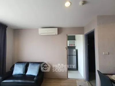 Modern living room with air conditioning and sleek black sofa