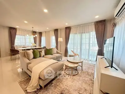 Spacious and elegant living room with modern decor and ample natural light.