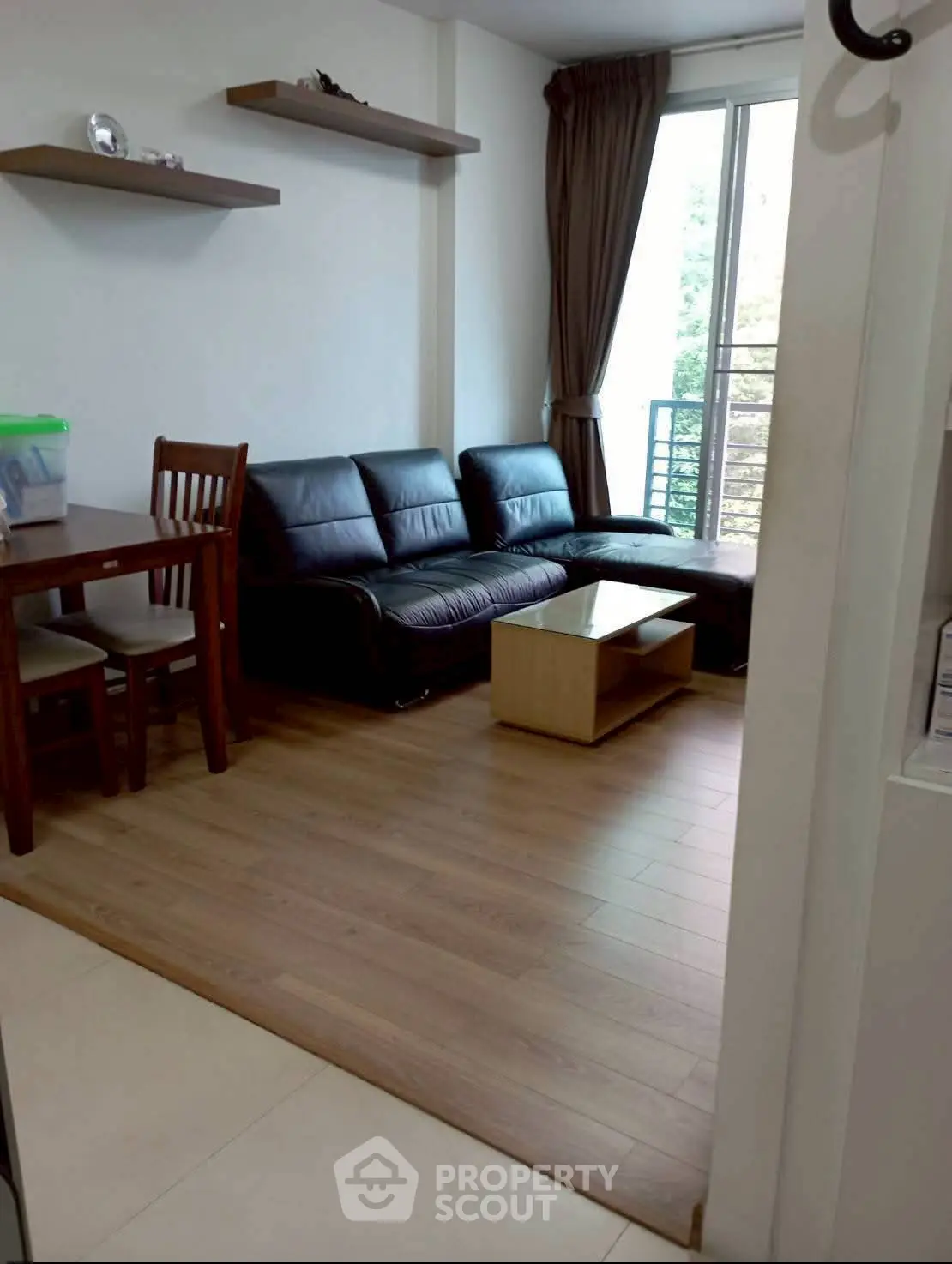 Cozy living room with wooden flooring and modern furniture, perfect for relaxation.