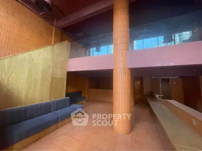 Spacious modern interior with unique architectural design and stylish seating area.