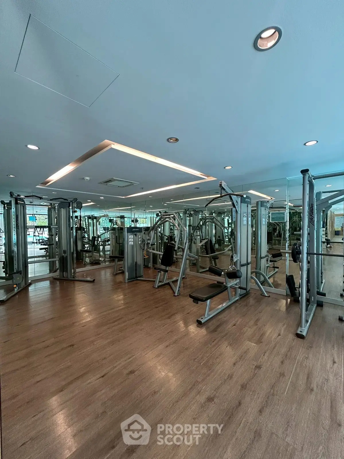 Spacious modern gym with state-of-the-art equipment and mirrored walls