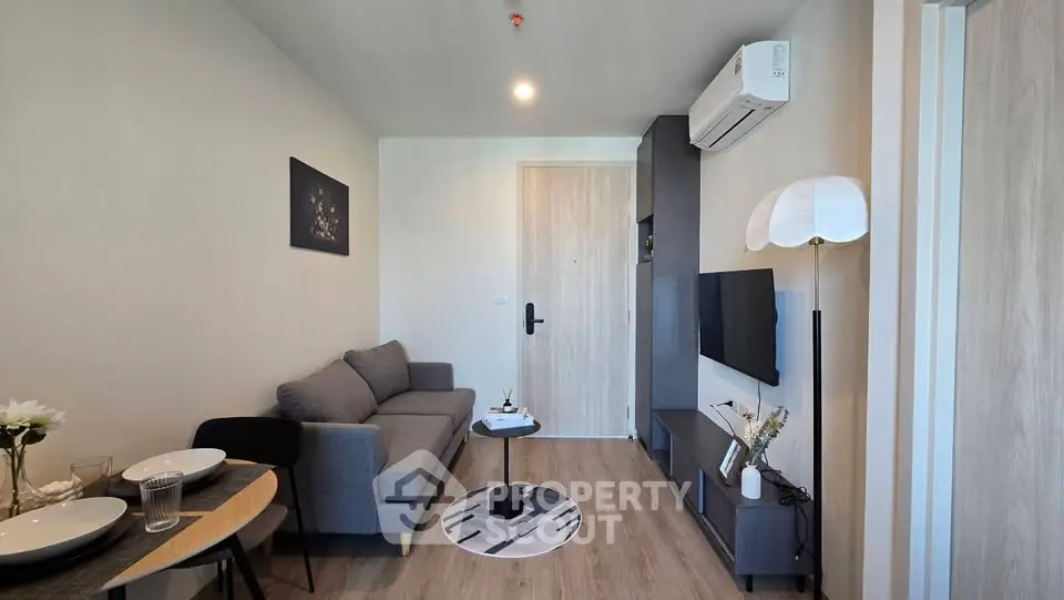 Modern living room with stylish decor and cozy seating in a contemporary apartment.